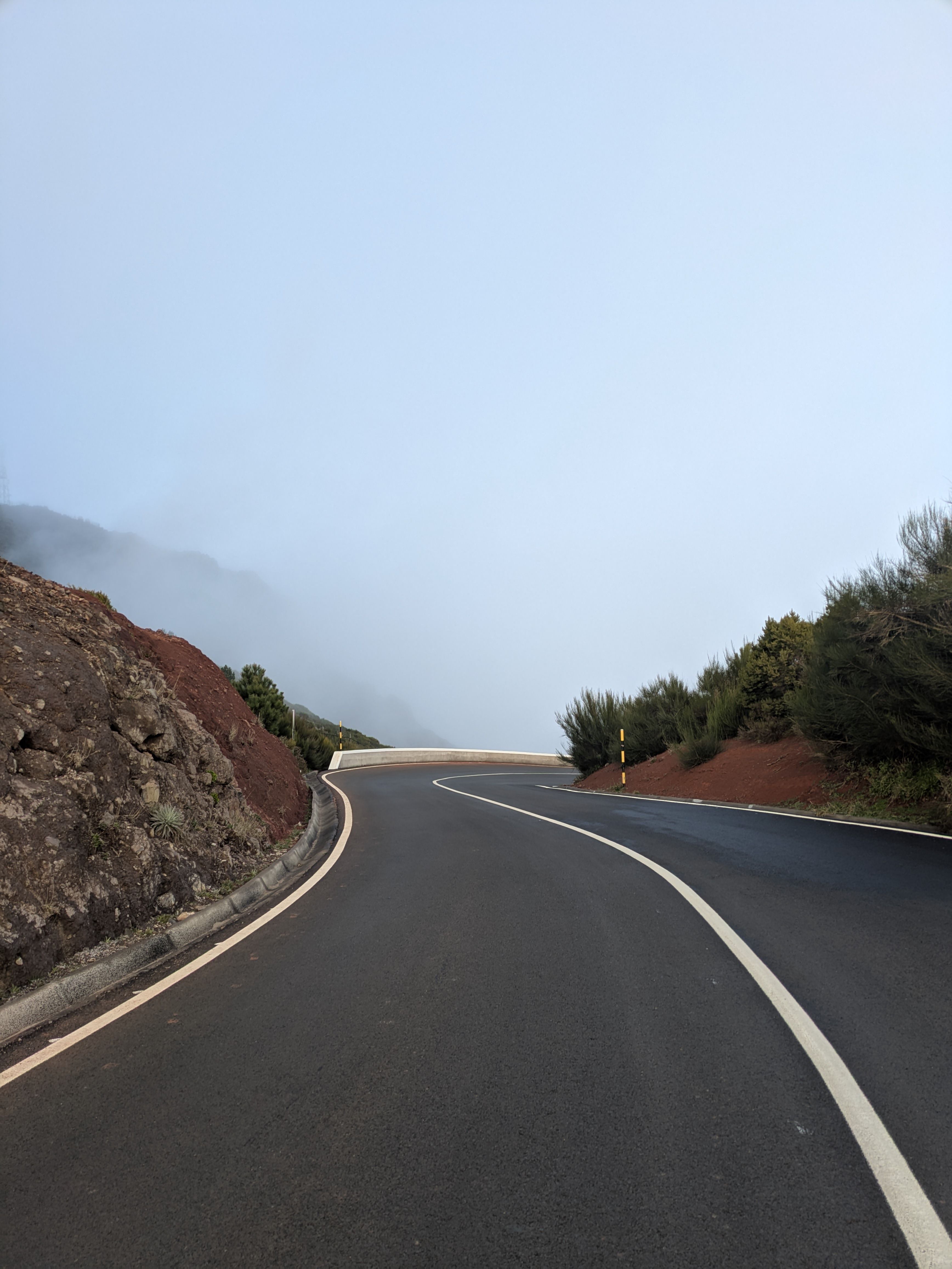 Curvy road between red, earthy hills