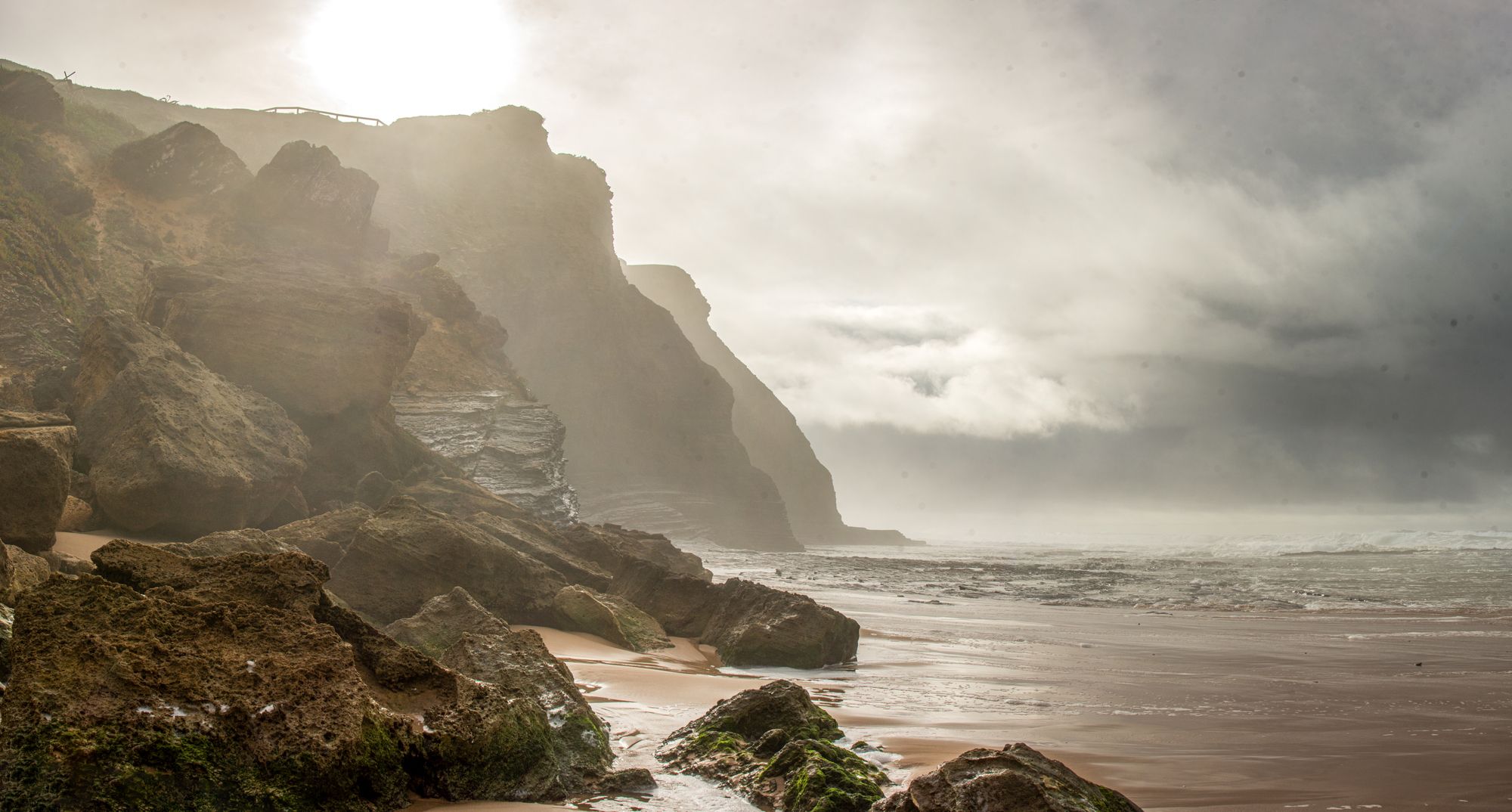 a rocky beach with water and cliffs